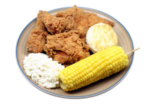 Plate of fried chicken and corn on the cob.